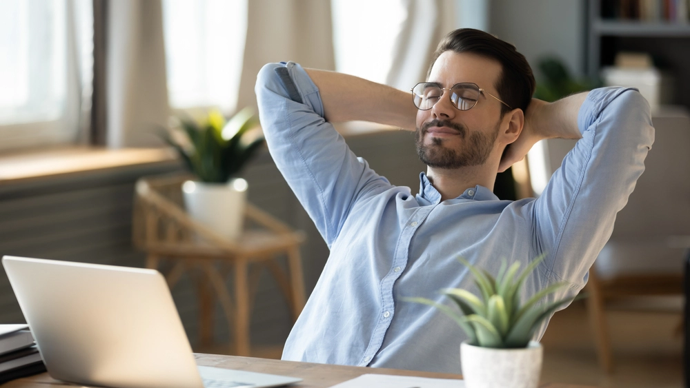 Man relaxed by desk