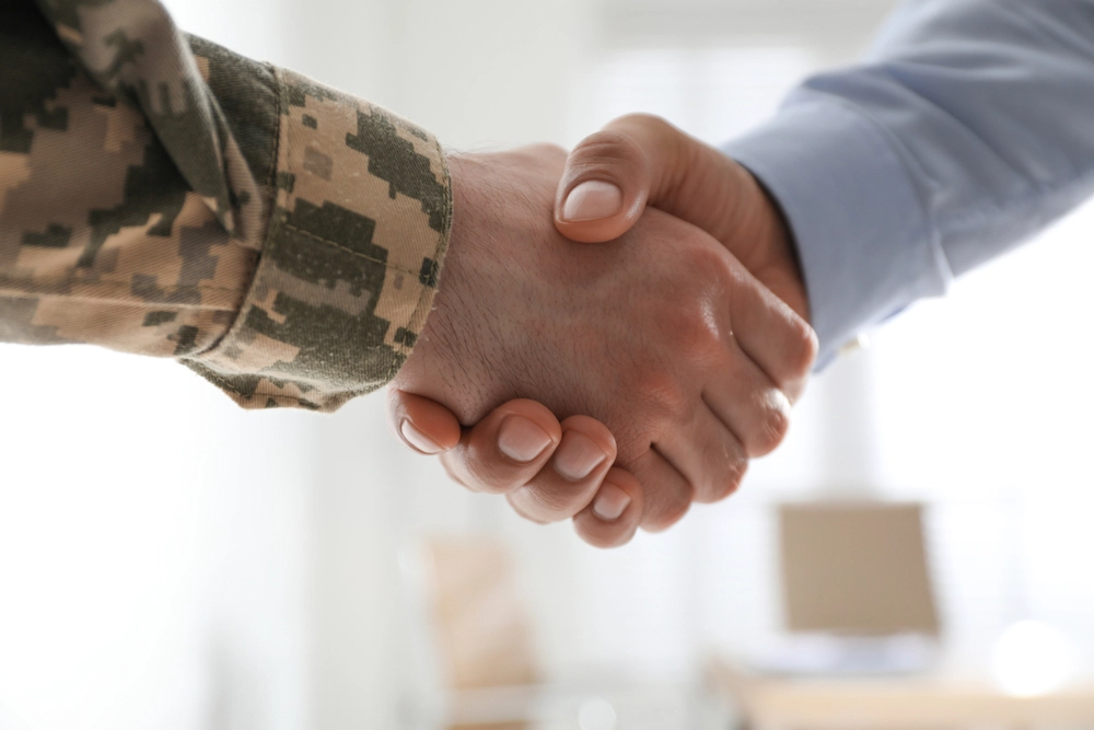 Soldier,And,Businessman,Shaking,Hands,Indoors,,Closeup