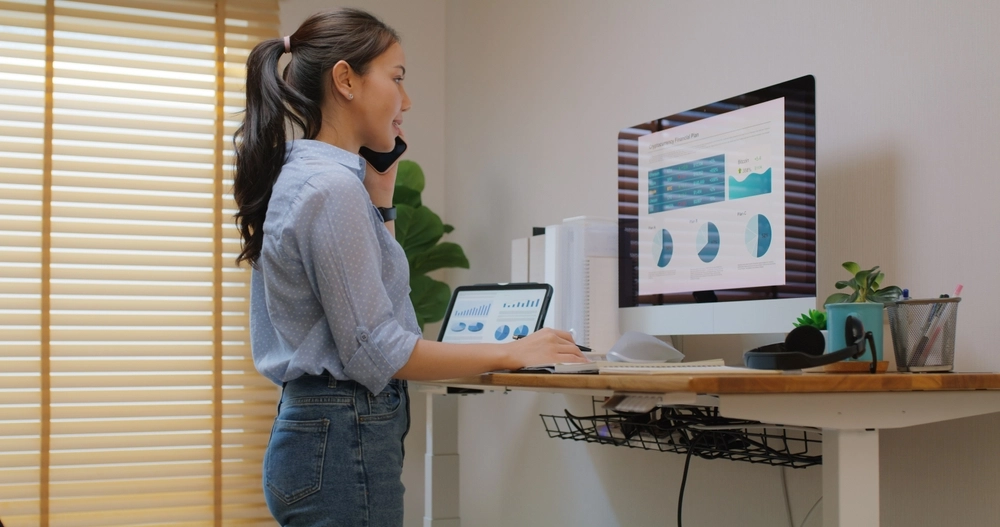 Electric,Adjustable,Standing,Desk,In,Small,Office,Workspace, woman, computer