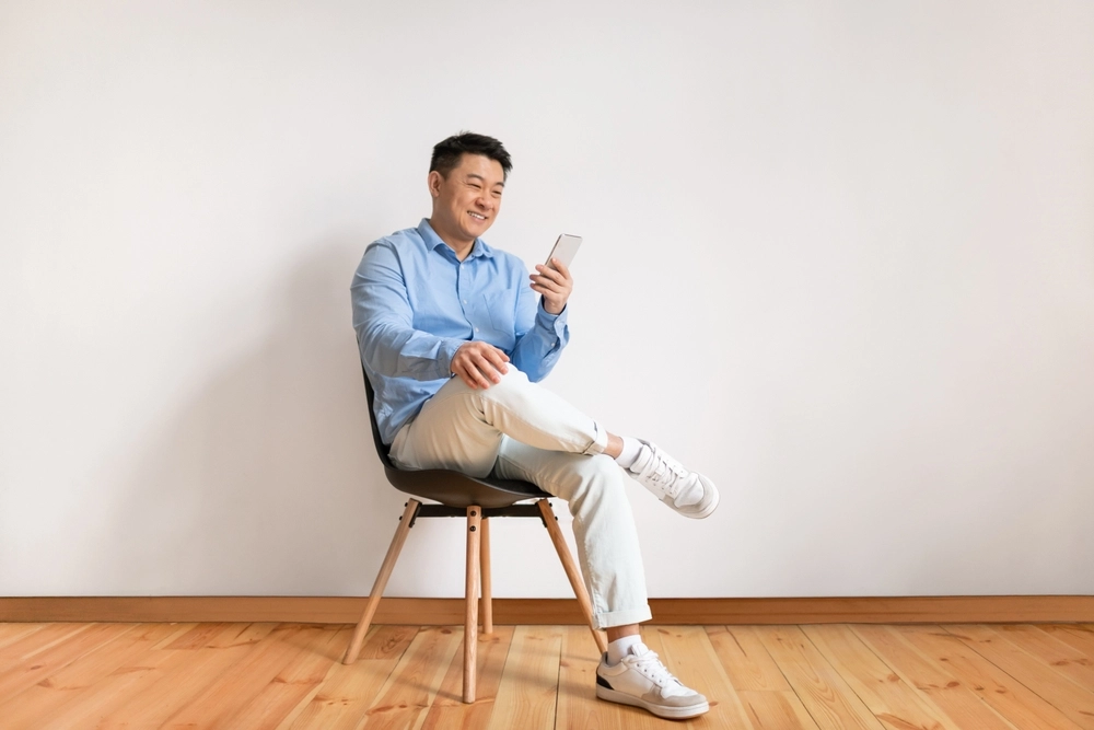 Man on chair with phone