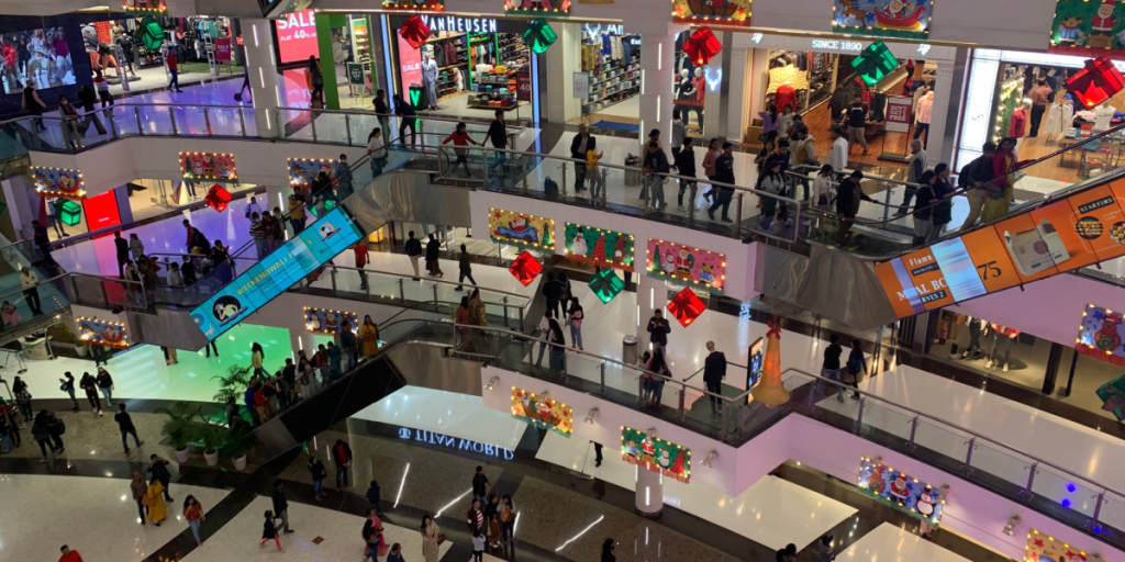 Kolkata, West Bengal, India - January 1, 2023: People are walking and riding escalator at crowded South City Mall. A lot of famous international brands are located at this popular shopping centre.