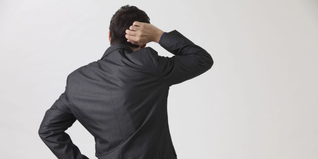 Scratching head, suit