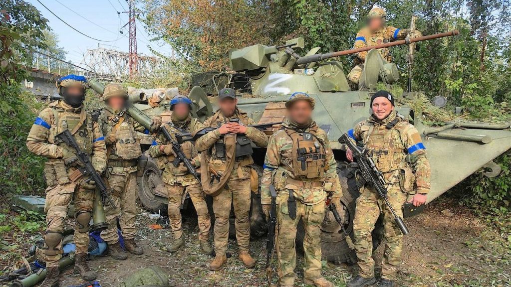 Soldiers of Ukraine Kraken special unit in front of the captured Russian BTR-82A