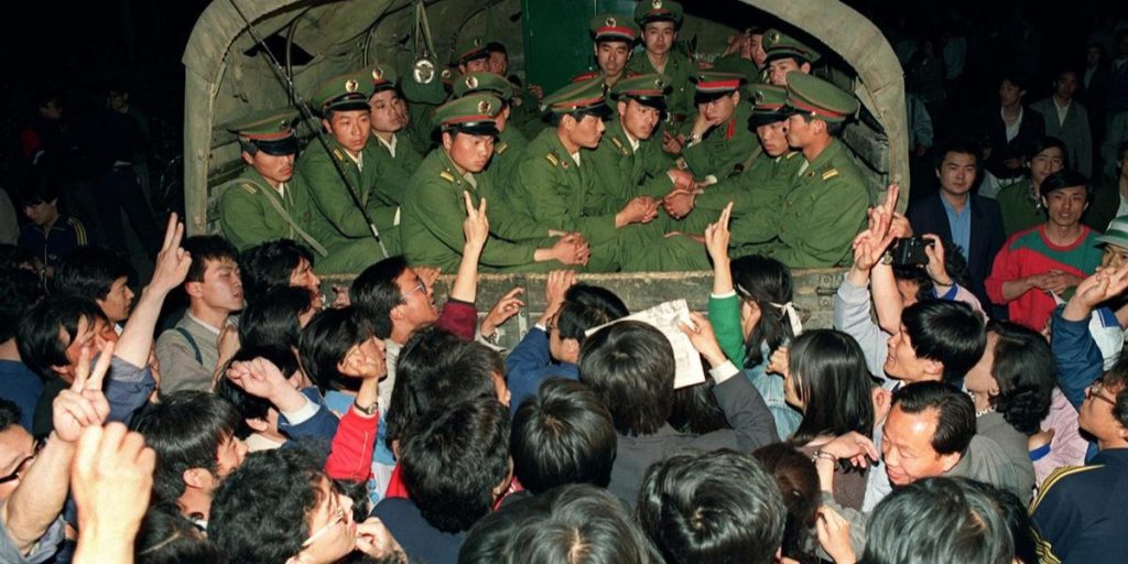 Red Army soldiers in a transport arrive at Tiananmen Square during the protests of 1989