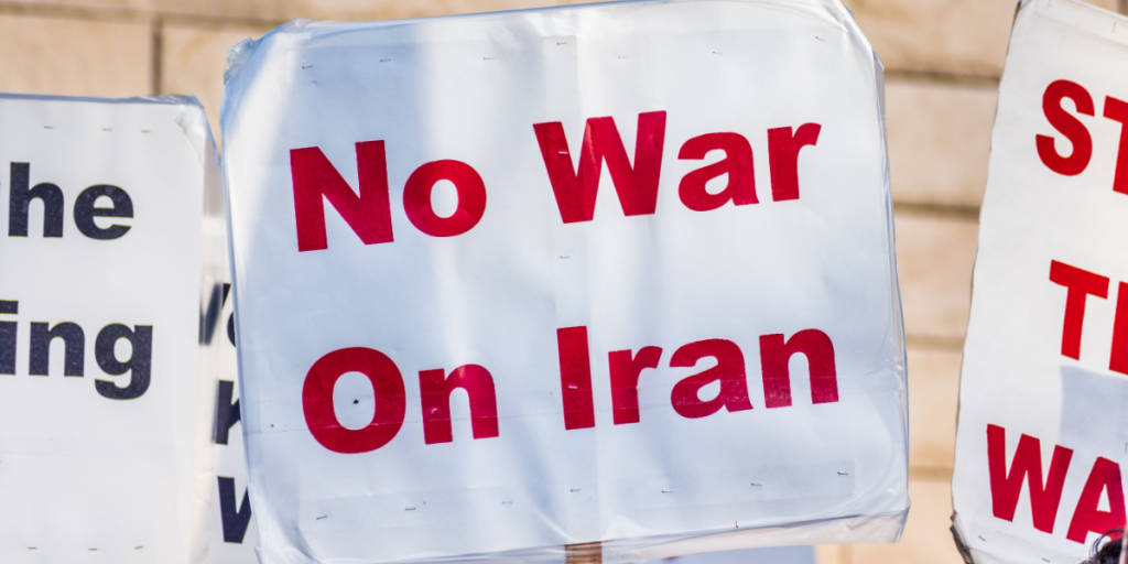Close up of No War On Iran sign raised at the anti-war protest in front of the Cityhall in downtown San Jose