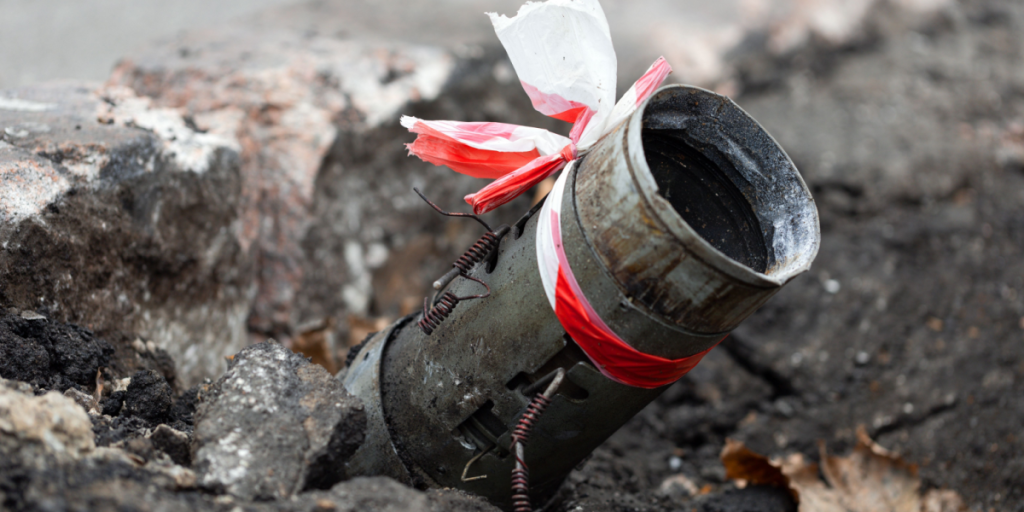Fragment of a Russian rocket 122mm hail sticking out of the asphalt in the center of Kherson, Ukraine. Genocide of the Ukrainian. Russia shells the civilian population and the city. War crimes. BM-21
