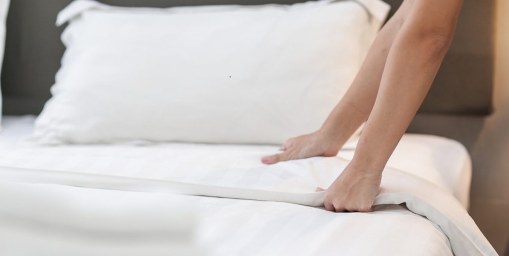 Hands,Making,Bed,From,Hotel,Room,Service