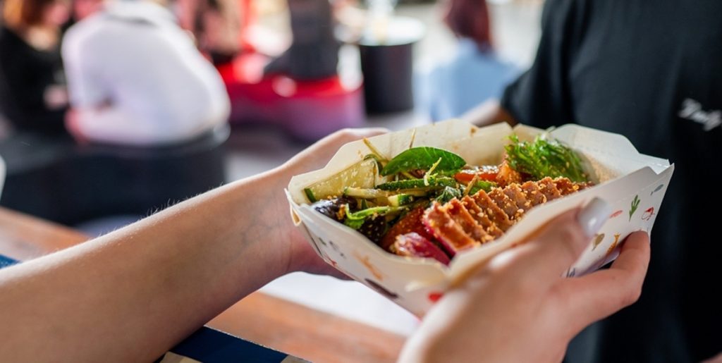 Hands,Holding,A,Paper,Container,Filled,With,Asian,Street,Food,