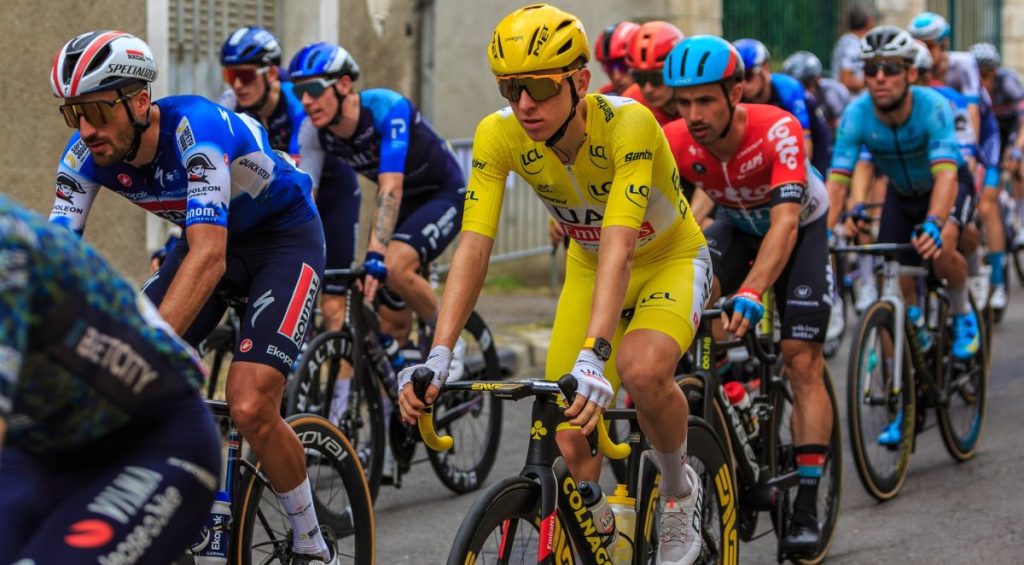 he Slovenian cyclist Tadej Pogacar of UAE Team Emirates, in the yellow jersey, rides in the peloton during stage 10 of the Tour de France 2024