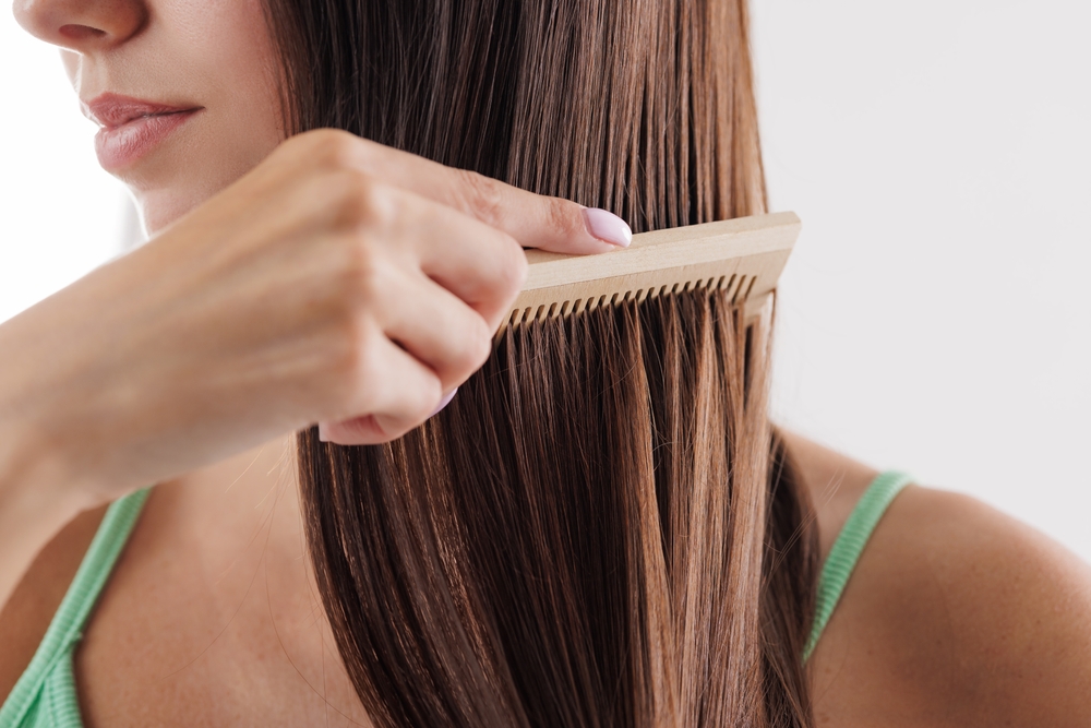 Close,Up,Of,Woman,Combing,Her,Long,Straight,Brown,Hair