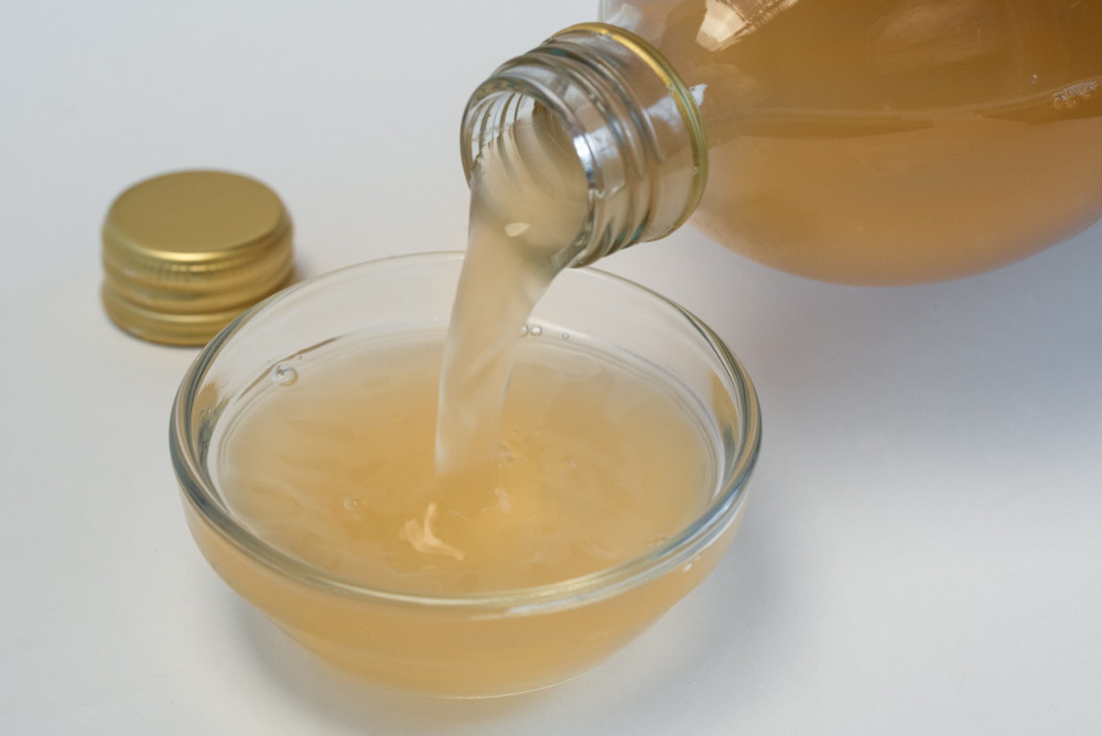 Pouring,Apple,Cider,Vinegar,Into,An,Ingredient,Bowl