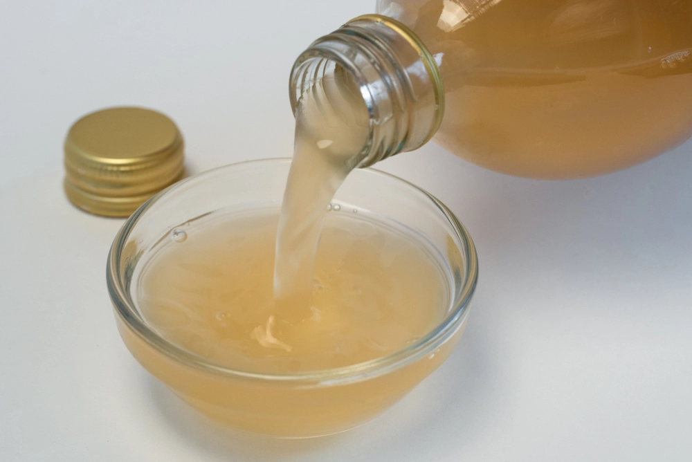 Pouring,Apple,Cider,Vinegar,Into,An,Ingredient,Bowl