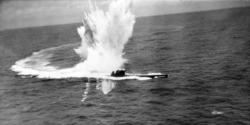 Oblique aerial photograph taken from Short Sunderland Mark III, W4030 'H', of No. 10 Squadron RAAF, while attacking German type VIIC submarine U-243, west of St Nazaire in the Bay of Biscay. Depth charges dropped by W4030, one of which crippled the U-boat, explode by its stern. Splashes from machine gun fire from the Sunderland's rear turret, which put both the submarine's 37-mm and port twin 20mm guns out of action, can be seen leading across the water below the DC explosion. After further attacks by another Sunderland of 10 Squadron RAAF and a Consolidated Liberator of the US Navy, U 243 was abandoned by its crew and sank. The U-boat lost 11 dead and had 38 survivors. A dinghy and food-pack were dropped for the survivors, nazi germany, WW2