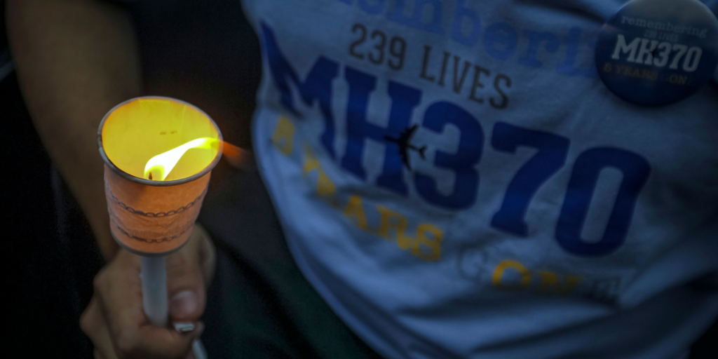 A man holds a candlelight during the remembrance ceremony to mark the fifth anniversary of the Malaysian Airlines flight MH370 plane's disappearance