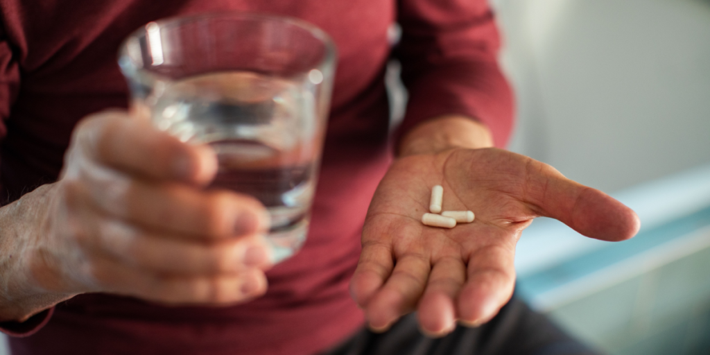 Senior, taking pills, pain killer