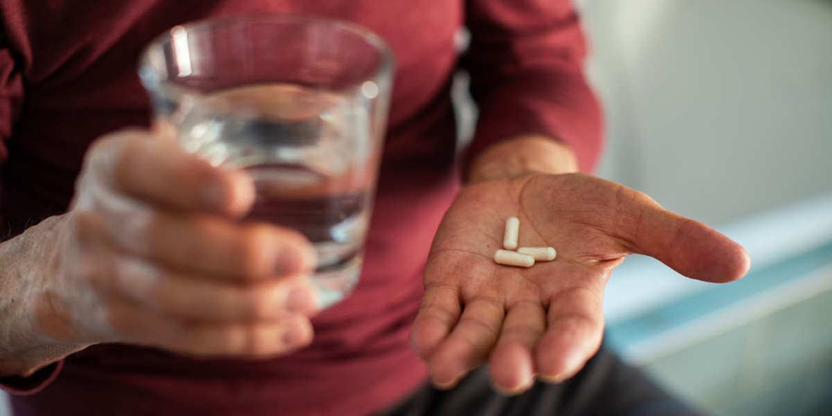 Senior, taking pills, pain killer