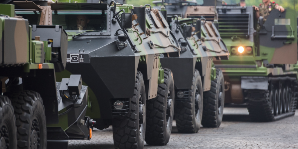 Armored vehicles of the French army in front of the monument Arc de Triumph preparing to march on Champs Elysees (Elysian fields) for the French national day.