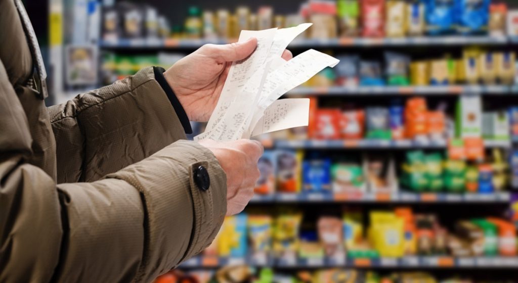 Minded,Man,Viewing,Receipts,In,Supermarket,And,Tracking,Prices