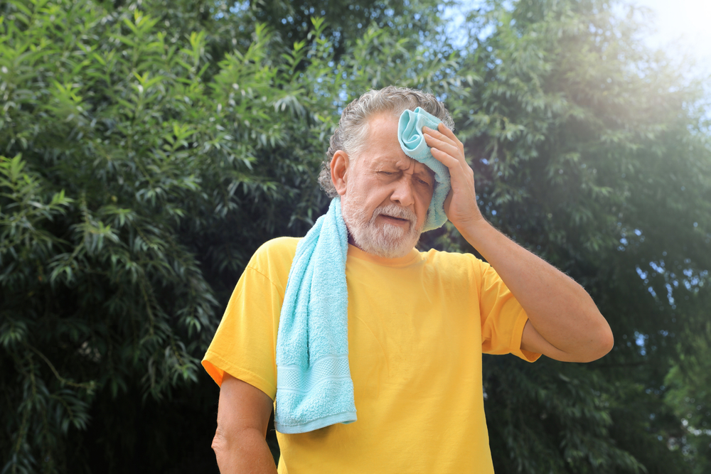 Senior,Man,With,Towel,Suffering,From,Heat,Stroke,Outdoors