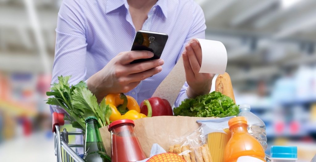 Woman,Checking,The,Grocery,Receipt,Using,Her,Smartphone, bill