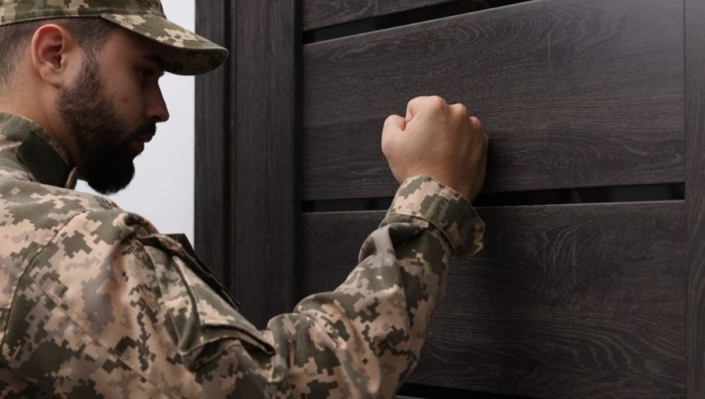 soldier knocks on door home visit