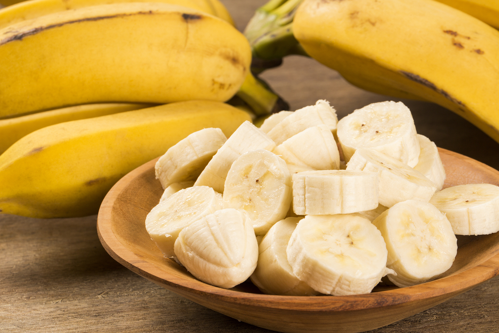 A,Banch,Of,Bananas,And,A,Sliced,Banana,In,A