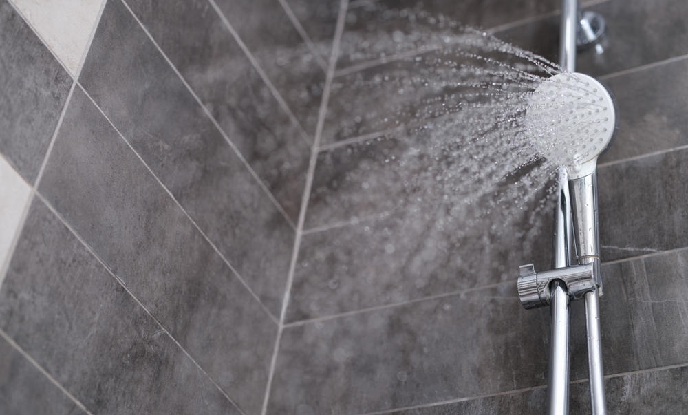 Water,Is,Pouring,From,The,Shower,Head,Into,The,Shower