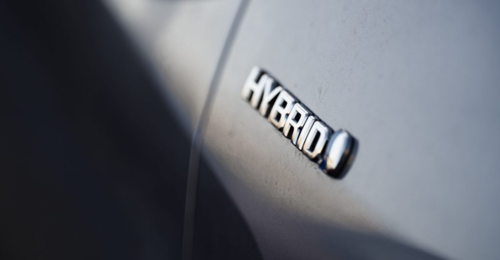Close up view of hybrid logo on a hybrid plugin car