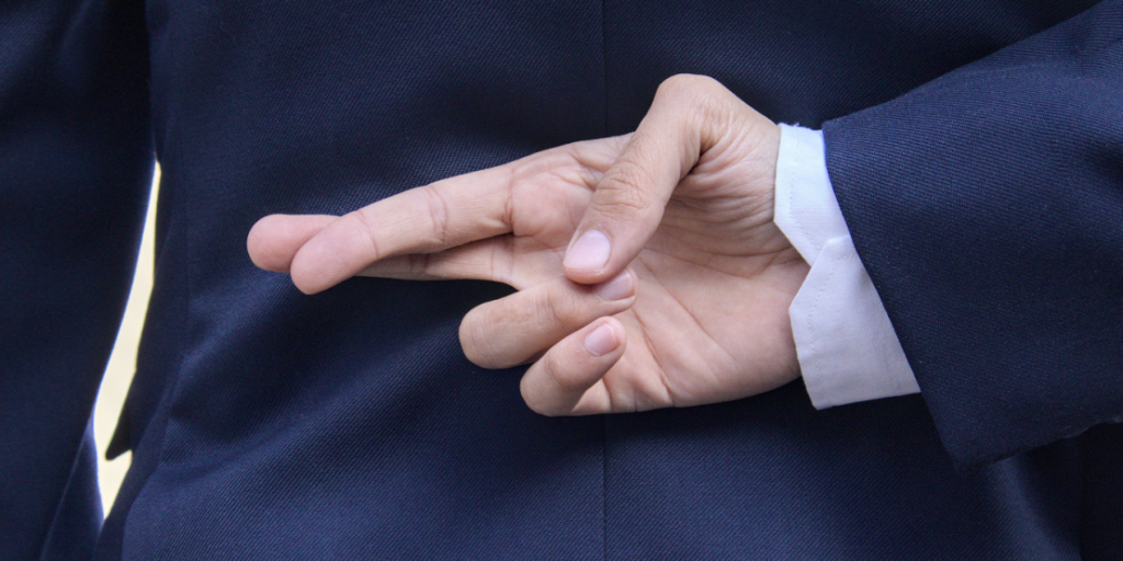 Fingers crossed, crossing fingers, hoping, lying, cheating, suit, business, dishonest