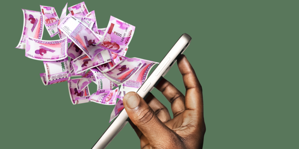 Hand holding mobile phone with many Indian rupee notes coming spitting flying out of the screen. side view of phone