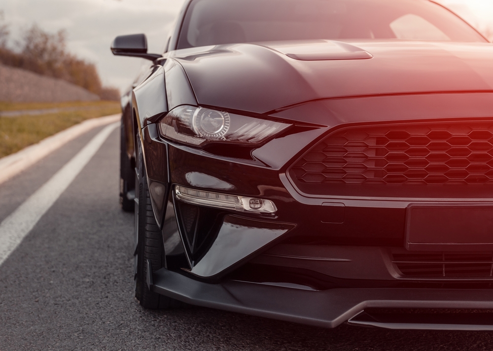 Black,Ford,Mustang,Parked,By,A,Curb,On,Highway.,Front