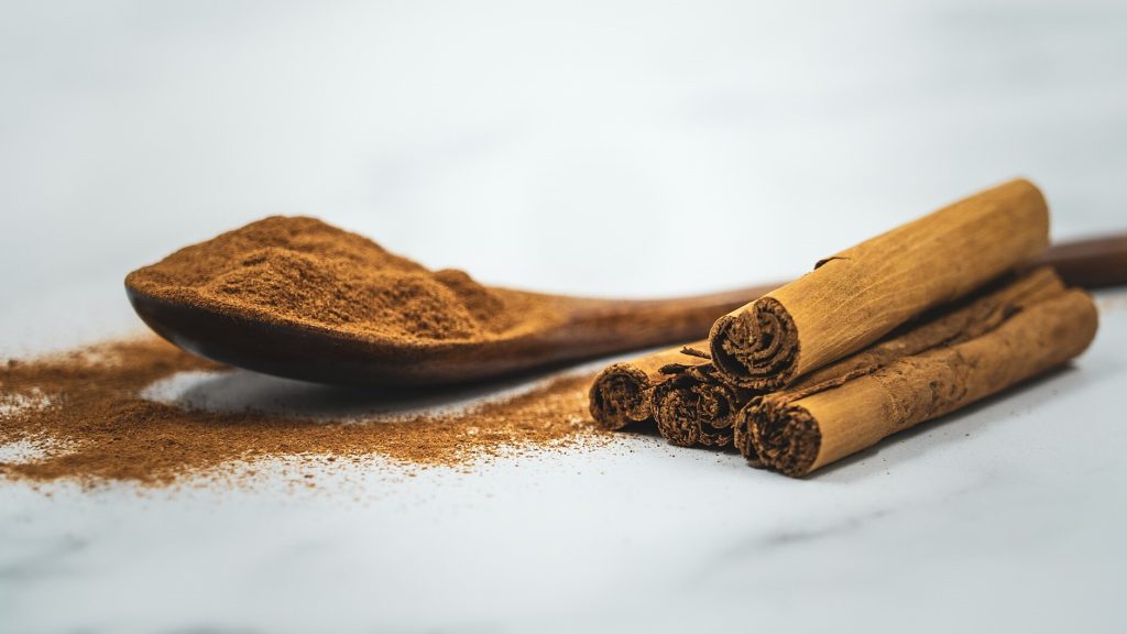 Ground Cinnamon Powder and a Cinnamon Stick