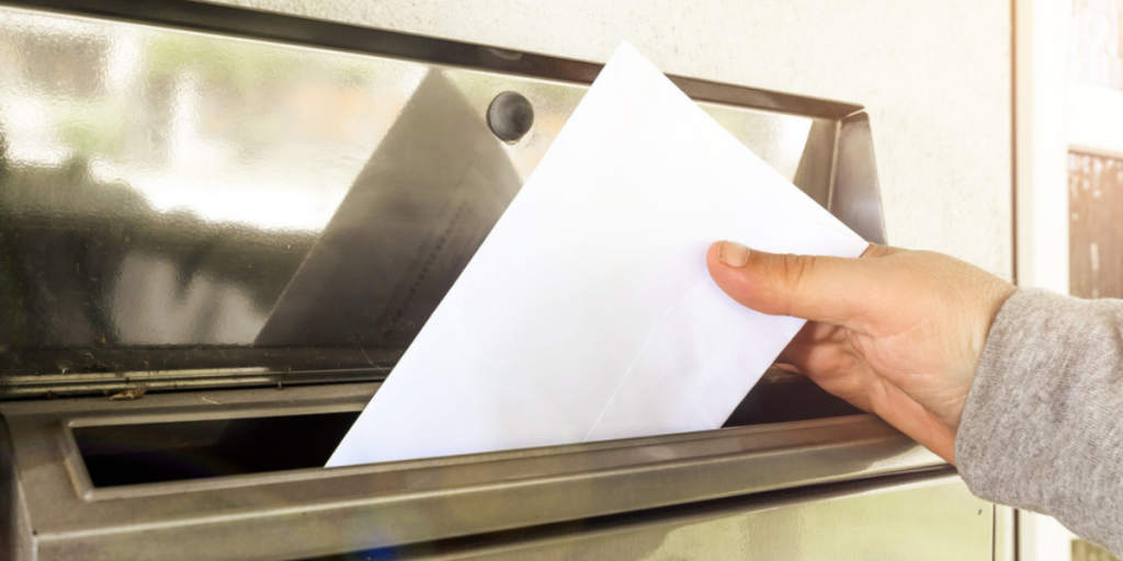 putting mail in mailbox.