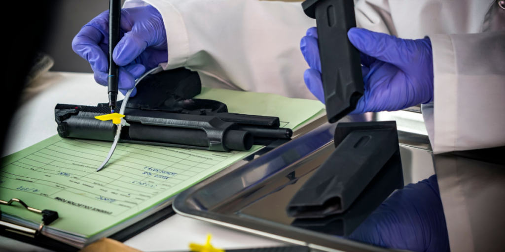 Police scientist notes serial number on sealed firearm in crime lab