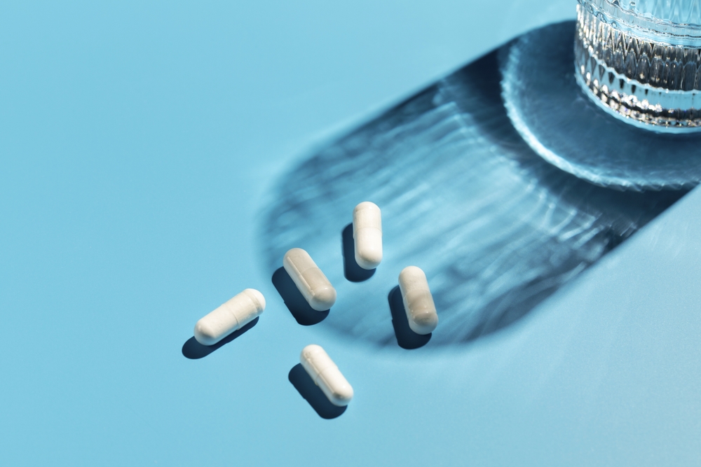White capsules with vitamins or a dietary supplement,medicine,medicin