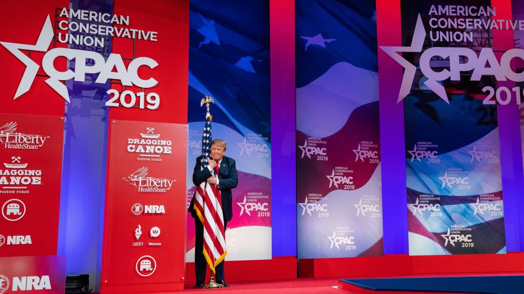 donald Trump hugging the American flag