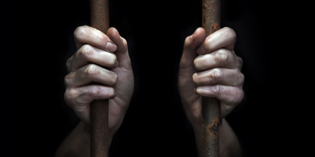 Woman, jail, behind bars