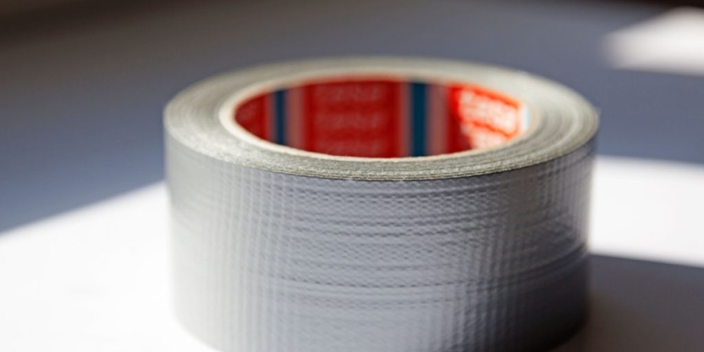 A roll of duct tape lying on a table.