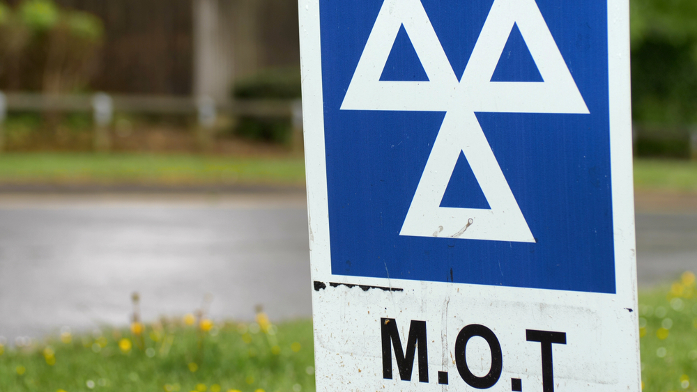 Blue,Mot,Service,Sign,On,British,Road,On,Cloudy,Rainy,Day