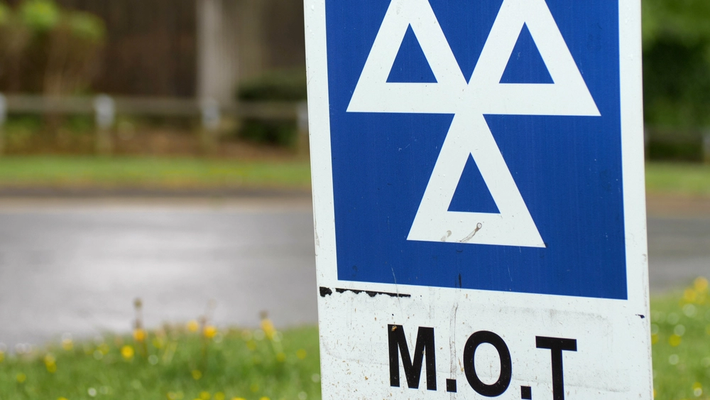 Blue,Mot,Service,Sign,On,British,Road,On,Cloudy,Rainy,Day