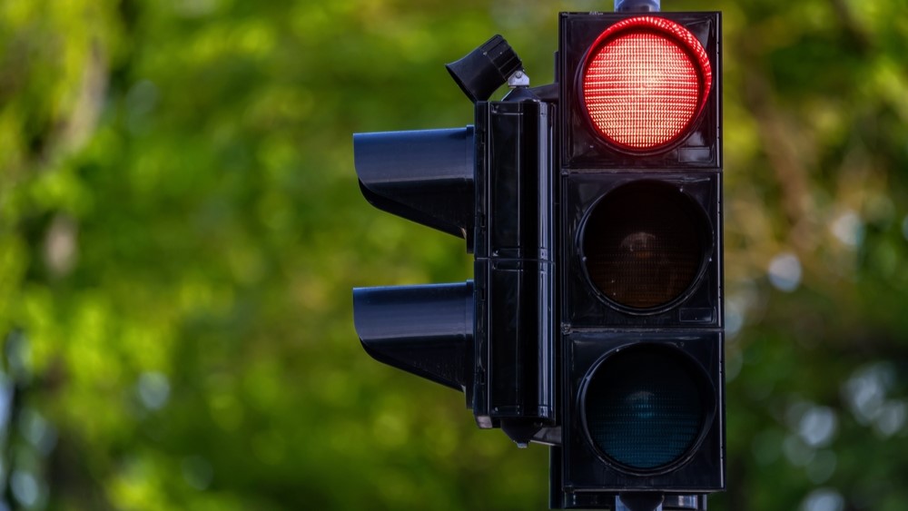 A traffic light showing a red light signal. Background with selective focus and copy space.