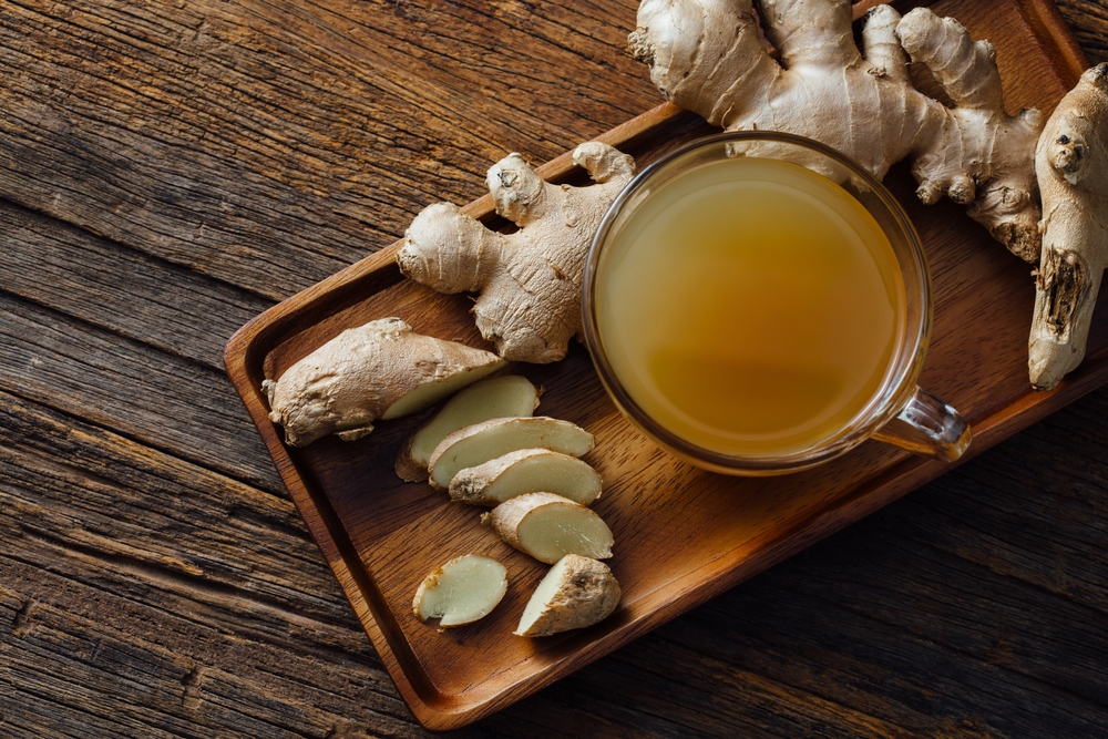 Ginger,Water,With,Fresh,Ginger,On,Wooden,Background