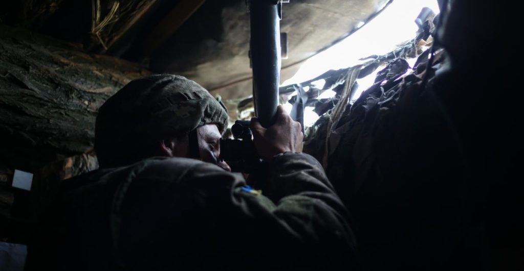 A Ukrainian soldier observes enemy lines through a periscope from a bunker in Avdiivka, Ukraine during the Donbas War on May 10th, 2019.