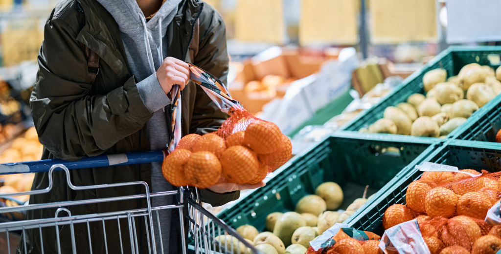 woman shops oranges at supermarket fruits and veggies
