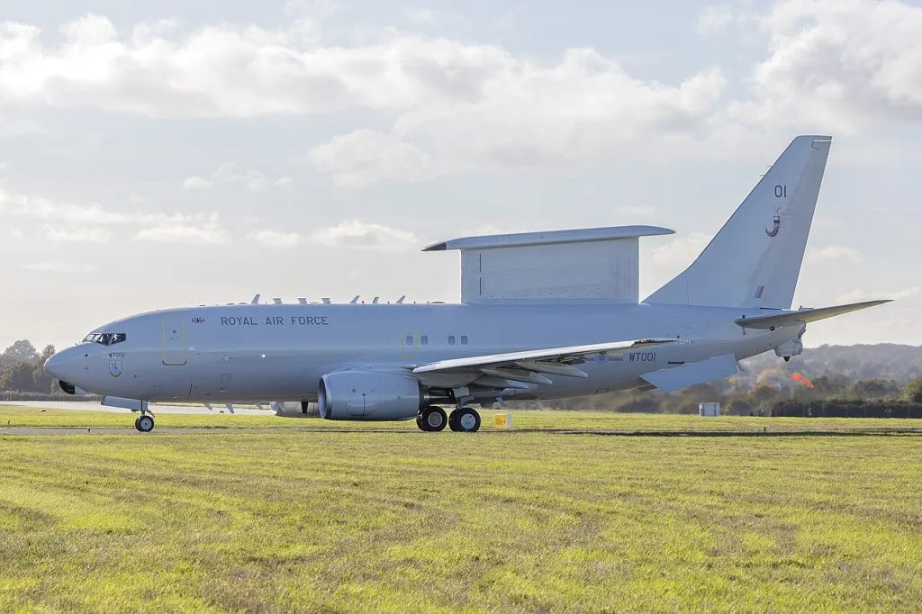 On the 17th of October 2024 the Royal Air Force’s (RAF) first E7 AEW&C (Airborne Early Warning and Control) aircraft rolled out from Satys Aircraft Livery at Southend Airport with its RAF Livery. This marks the first time that an E7 will be painted in its RAF scheme. The aircraft took off from Southend Airport and went on to land at Birmingham Airport. The Wedgetail is the most technologically advanced AEW&C system available and will provide UK Defence with eyes in the sky, to see far beyond ground-based systems and fighter aircraft sensors. Already in service and proven with the Royal Australian, Republic of South Korean and Turkish Air Forces, the platform has recently been selected by the United States Air Force and NATO as their next command and control aircraft. Capable of fulfilling a wide range of missions, Wedgetail will provide high fidelity and accurate target information utilising its cutting-edge Multirole Electronically Scanned Array housed in a distinctive fin on the spine of the aircr