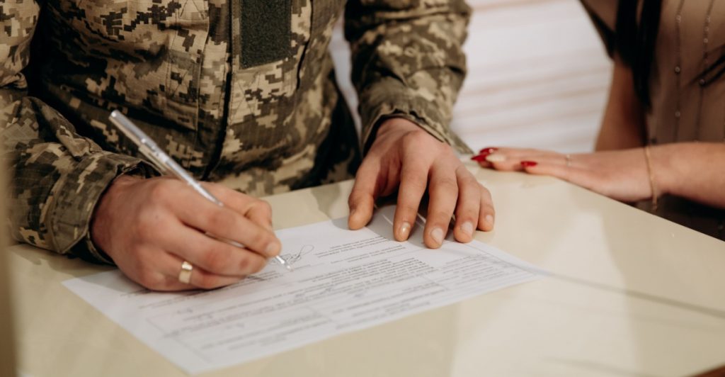 Contract, soldier signing papers