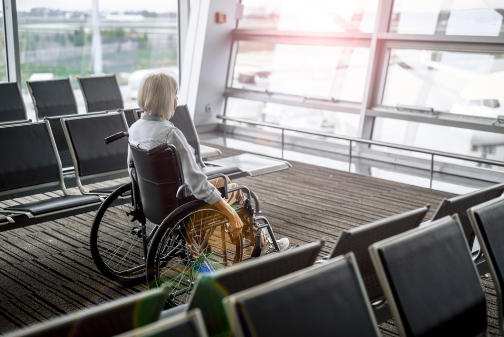 Side,View,Photo,Of,Old,Woman,Moving,In,Wheelchair,At