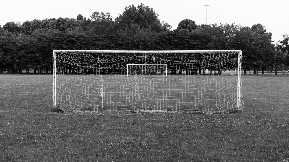 Abandoned,Soccer,Field,In,A,Milan,Park,,Italy.,Damaged,Football