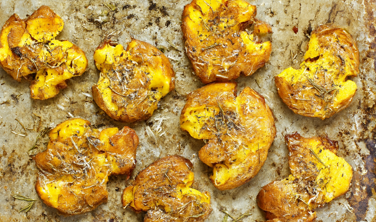 Smashed,Potato,,On,Parchment,Paper,Just,Out,Of,The,Oven.