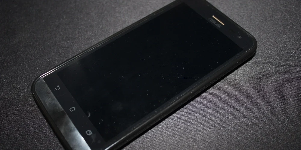 Asus phone laying on black surface